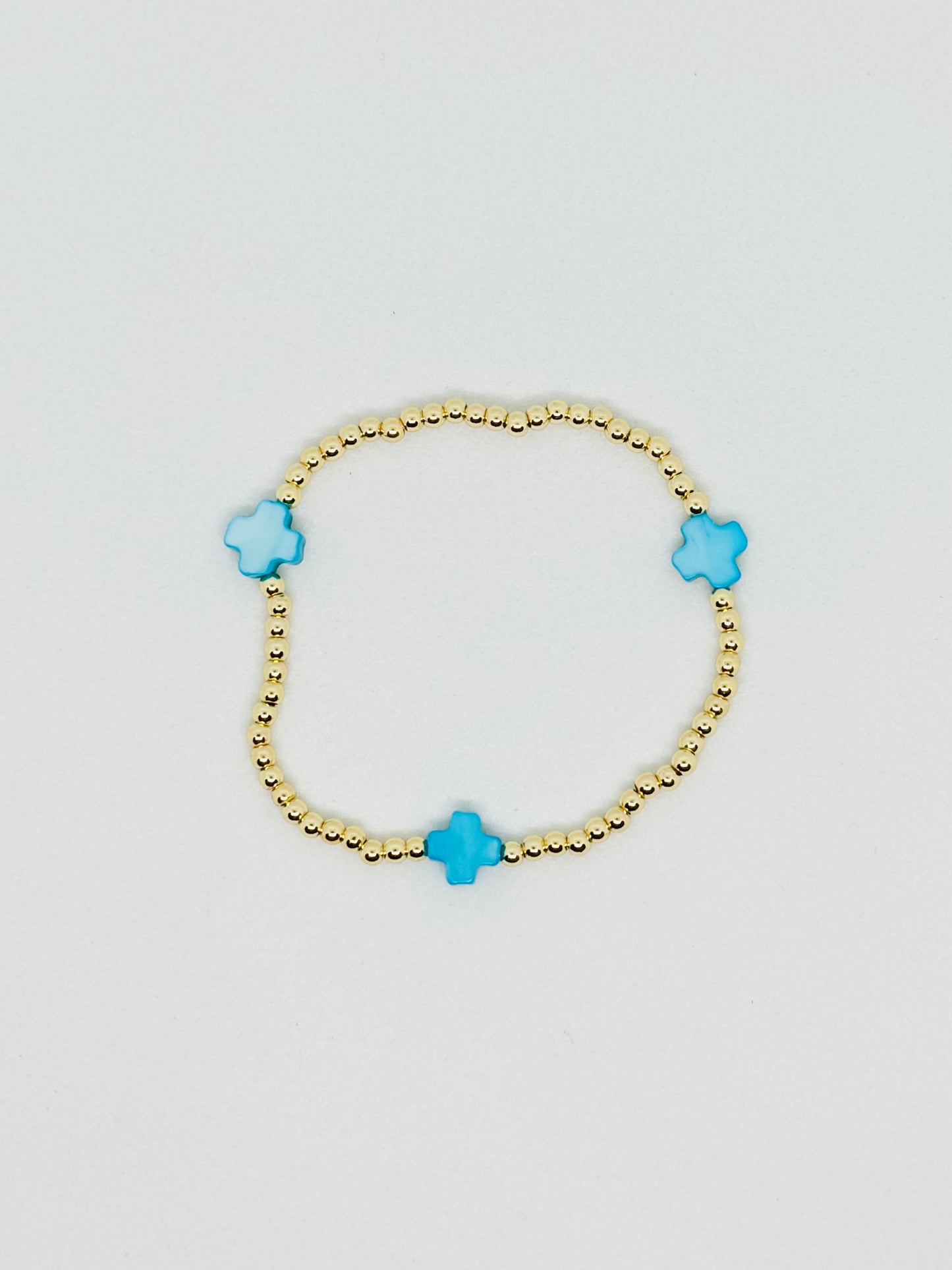 H L M Gold Beaded Cross Bracelet